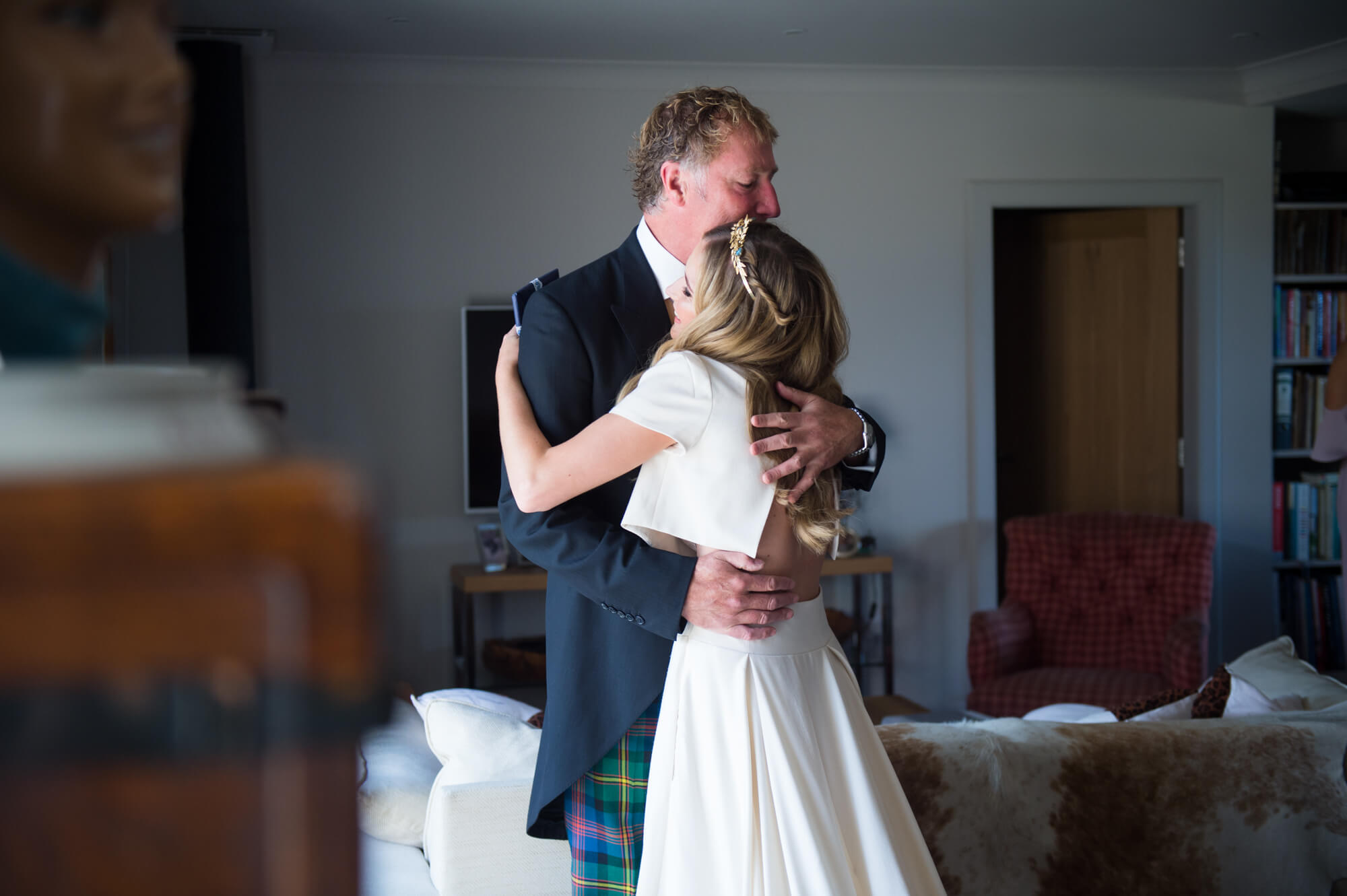 A bride hugging her father 